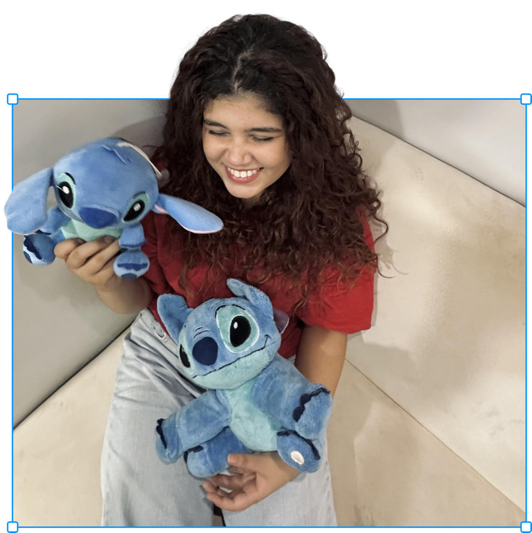 Nabia holding Stitch plushies